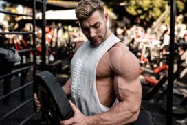 Bodybuilder Looking at Biceps while Holding Weight