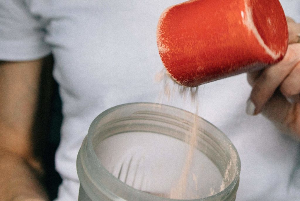 Close Up of Protein Being Poured into Shaker