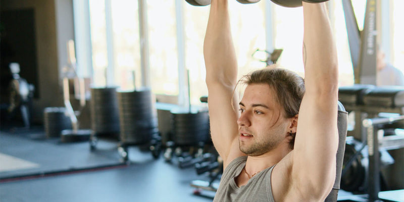 Man Doing Shoulder Presses at Gym