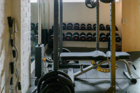 Small Gym with Dumbbells, a Squat Rack, and a Bench